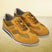 A yellow Men's bugatti Casuals Shoes featuring a round toe wing tip, zero heels heel, and a wide fit. Made from premium genuine leather with a durable tr outsole, this laces design offers both style and comfort.