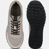 Taupe leather sneakers by bugatti with black laces and a lugged black outsole.