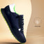 Side view of a bugatti Cirino dark blue sneaker with premium leather, a zipper, and green soles.
