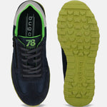 Dark blue premium leather sneakers by bugatti, showing the sole with green details, laces, and zip.
