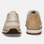 Sand-colored leather sneakers by bugatti, with off-white accents, stacked sole, and orange stripe detailing.
