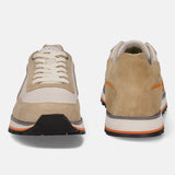 Sand-colored leather sneakers by bugatti, with off-white accents, stacked sole, and orange stripe detailing.