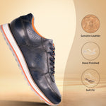 Dark blue leather comfort sneaker by bugatti with orange trim accents, standing on a reflective surface in side view.