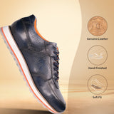 Dark blue leather comfort sneaker by bugatti with orange trim accents, standing on a reflective surface in side view.