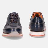 Dark blue leather sneakers by bugatti with orange shoelaces and orange accents.
