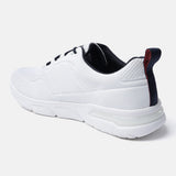 White sneaker by bugatti with black interior, laces, and a navy blue heel pull tab with a red stripe.