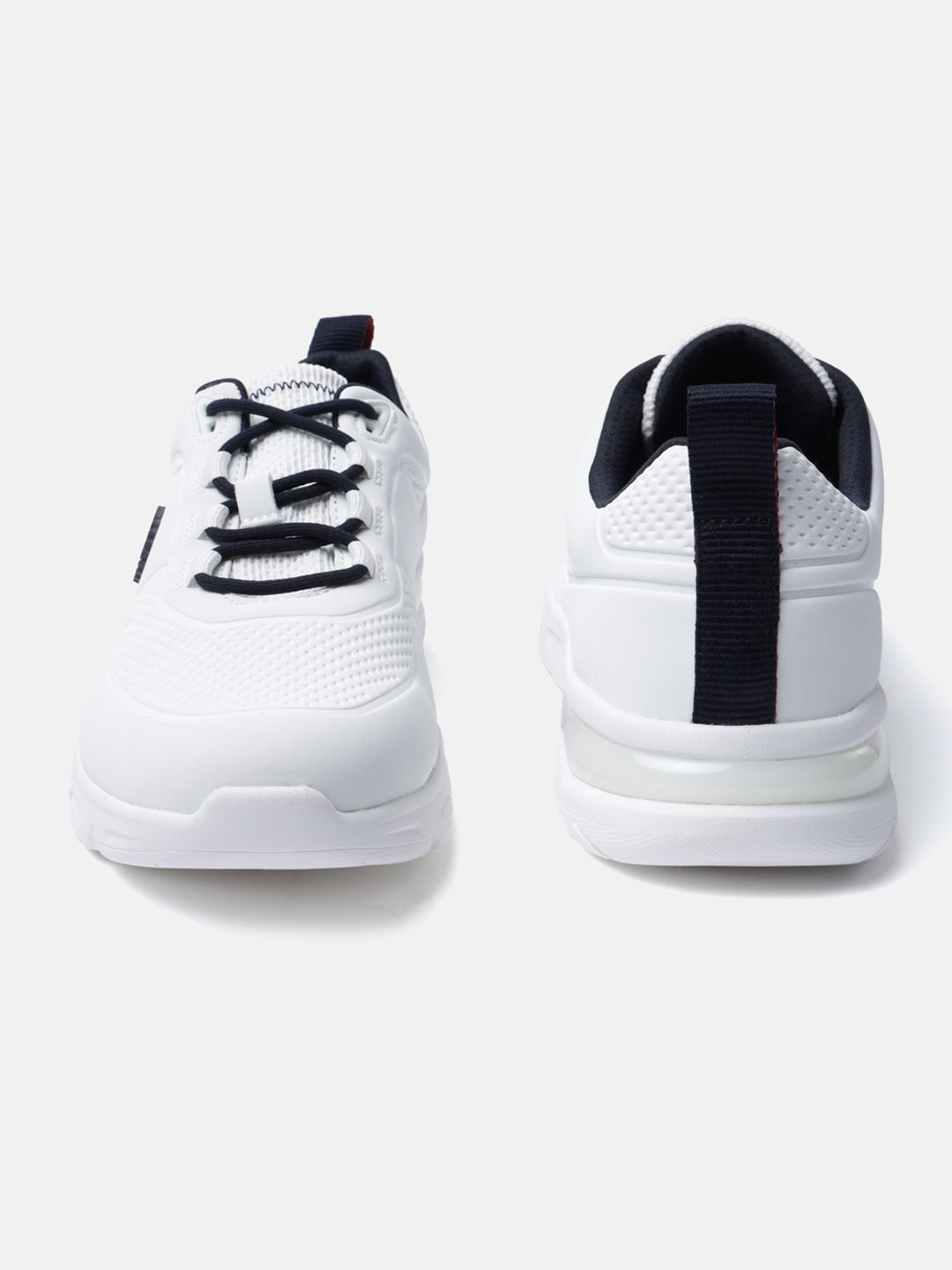 White comfort sneakers by bugatti with navy blue accents on the laces and heel.