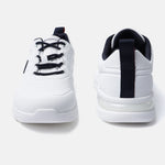 White comfort sneakers by bugatti with navy blue accents on the laces and heel.