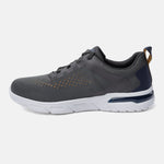 Dark grey sneaker by bugatti with white soles, dark textile details, and tan heel loop, in a side view.
