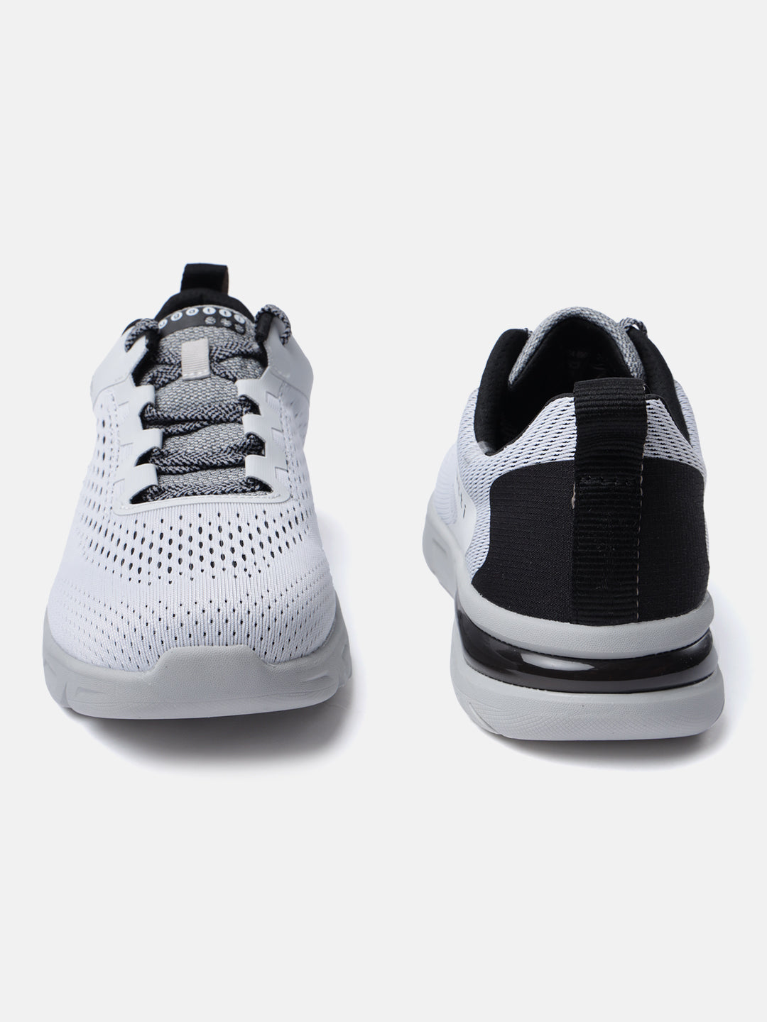 White comfort mid-top sneakers by bugatti, with a textured upper and black accents at the heel.
