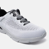 White comfort sneakers by Bugatti with black and grey laces and a white perforated upper.
