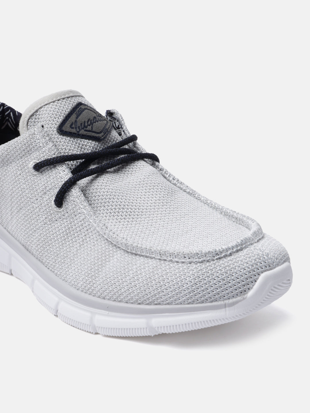 Light gray comfort sneakers by bugatti with dark laces and textured knit upper.