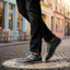 Lifestyle shot of bugatti Bimini grey low top sneakers with a knit texture and black laces.
