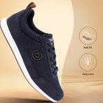 Dark blue sneakers by bugatti, with a white sole and a brown leather heel tab.