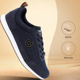 Dark blue sneakers by bugatti, with a white sole and a brown leather heel tab.