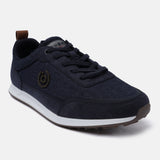 Dark blue denim sneaker by bugatti with brown accents at the heel and sole, and an emblem on the side.