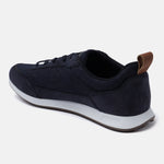 Dark blue sneakers by bugatti, with a tan heel tab and white midsole, in a side view.