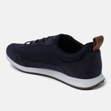 Dark blue sneakers by bugatti, with a tan heel tab and white midsole, in a side view.