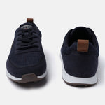 Dark blue denim sneakers by bugatti, with brown leather heel and tongue pulls, and a white and brown sole.