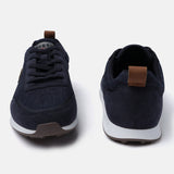 Dark blue denim sneakers by bugatti, with brown leather heel and tongue pulls, and a white and brown sole.