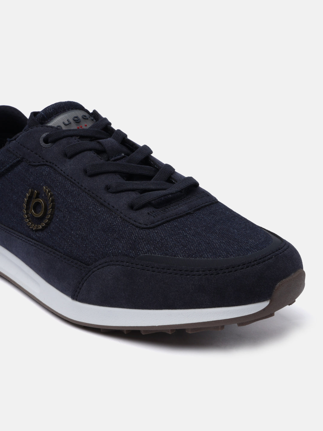Dark blue sneaker by bugatti, with textile uppers, lace-up closure, and a brown textured outsole.