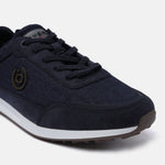 Dark blue sneaker by bugatti, with textile uppers, lace-up closure, and a brown textured outsole.