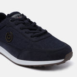 Dark blue sneaker by bugatti, with textile uppers, lace-up closure, and a brown textured outsole.