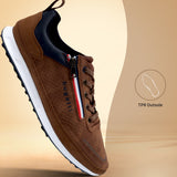 Side view of a brown bugatti sneaker with a white sole, zipper, and striped accent.
