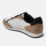 Beige comfort sneakers by bugatti with black and tan accents, shown from the back at an angle.