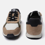 Beige casual sneakers by bugatti with black accents and suede texture.