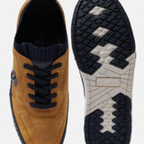 Yellow comfort sneakers by bugatti, shown with navy blue shoelaces and a patterned sole.