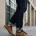 Lifestyle shot of the bugatti Vanadium Yellow comfort low-top sneakers on a person wearing dark jeans with rolled cuffs.