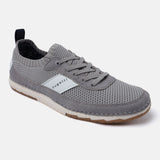 Grey low-top comfort sneaker by Bugatti, featuring a knit-textured upper, tonal laces, and a pull tab at the heel.