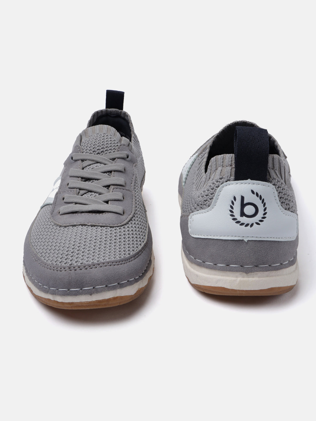 Grey low-top sneakers by Bugatti, showcasing a knit texture, lace-up design, and logo detail on the heel.