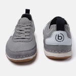 Grey low-top sneakers by Bugatti, showcasing a knit texture, lace-up design, and logo detail on the heel.