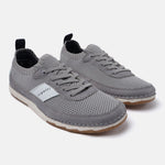 Gray knit low top sneakers by bugatti with suede trim and brown rubber outsoles.