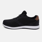 Black comfort sneaker by bugatti with a mesh and suede upper, and a brown heel accent, in a side view.
