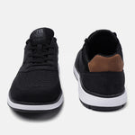Black comfort sneakers by Bugatti with a brown heel accent and white sole.