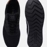 Black comfort sneakers by bugatti with brown heel counter and patterned black sole.