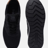 Black comfort sneakers by bugatti with brown heel counter and patterned black sole.