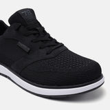 Black comfort sneakers by bugatti, featuring a textile upper with tonal stitching and white midsole.