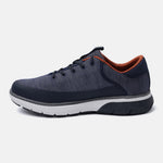 Dark blue comfort sneaker by bugatti with an orange interior, contrasted with a white and dark grey sole.
