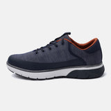 Dark blue comfort sneaker by bugatti with an orange interior, contrasted with a white and dark grey sole.
