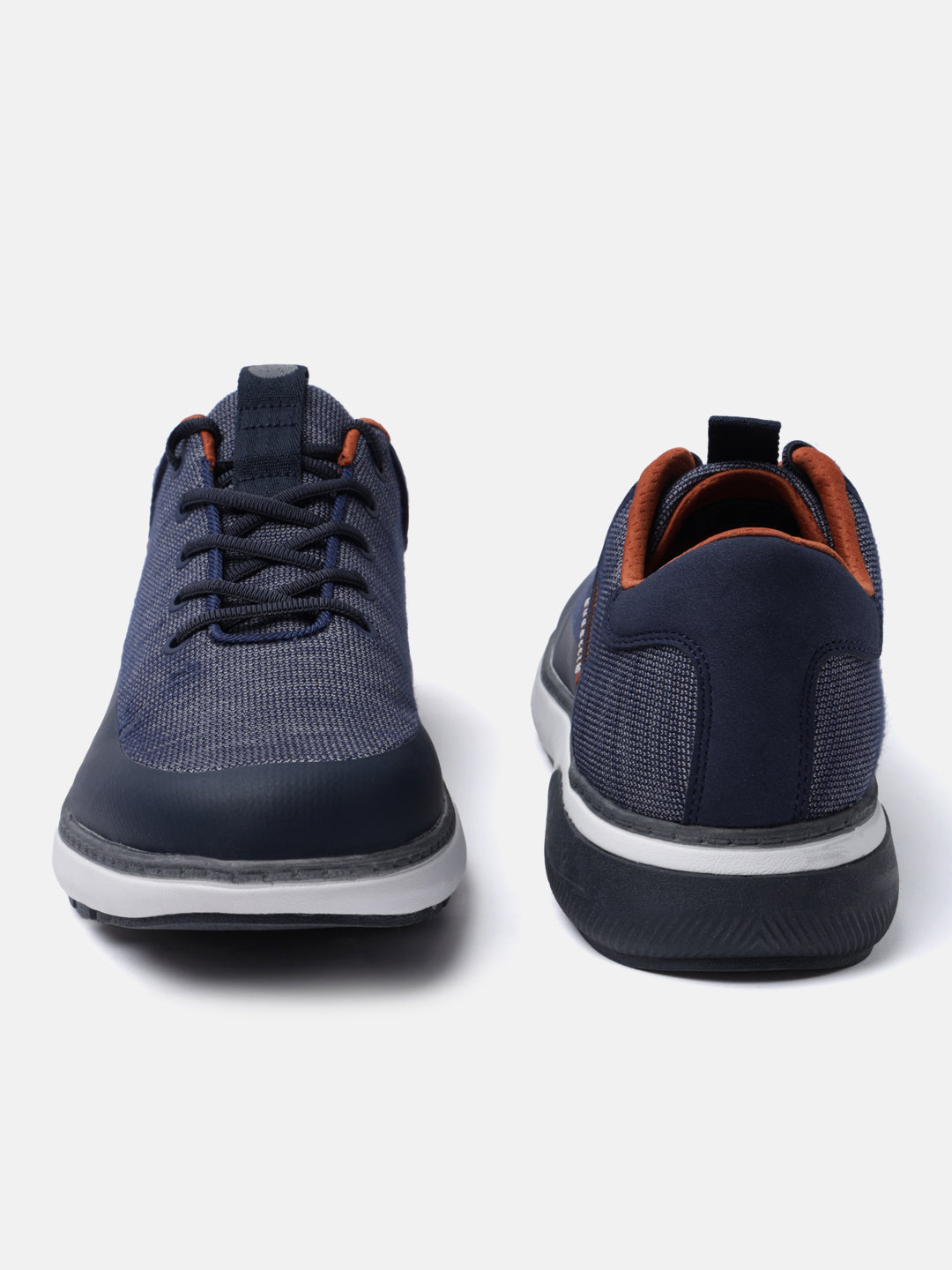 Dark blue comfort mid top sneakers by bugatti with a textured knit upper and brown trim around the ankle.