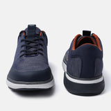 Dark blue comfort mid top sneakers by bugatti with a textured knit upper and brown trim around the ankle.