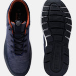 Dark blue sneakers by bugatti featuring orange trim, lace-up closure, and patterned sole.