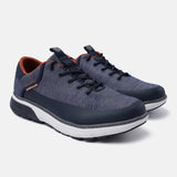Dark blue comfort sneakers by bugatti with a textured finish and orange inner lining.