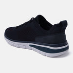 Dark blue comfort sneakers by bugatti with a textured knit upper and a contrasting white sole.
