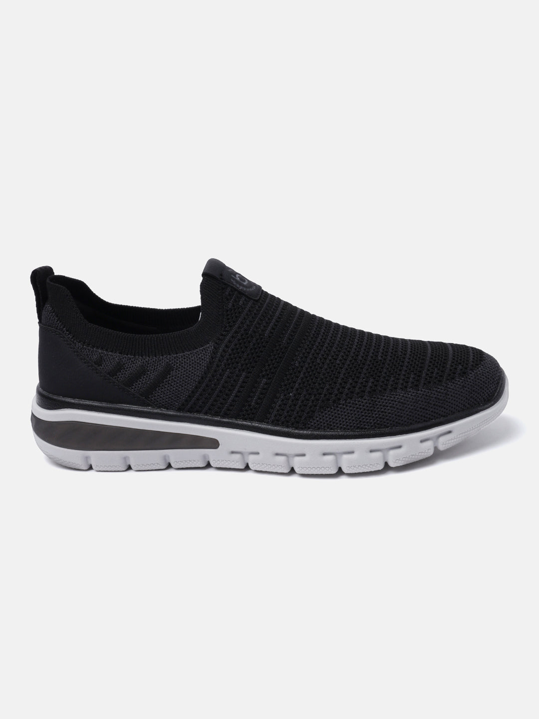 Black comfort sneakers by bugatti with a slip-on style, knit upper, and white sole.
