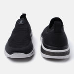 Black comfort sneakers by bugatti with a knit texture and a white sole.